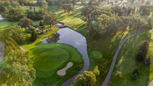 Aerial view of a green and surrounding water.