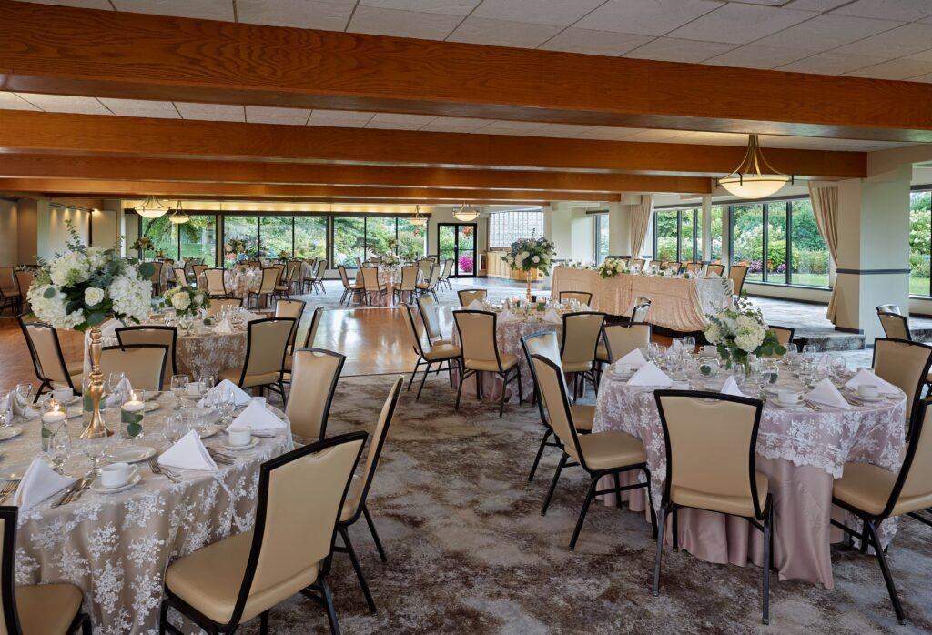 Many tables and chairs are set up for an upcoming banquet at the West Garden Room.