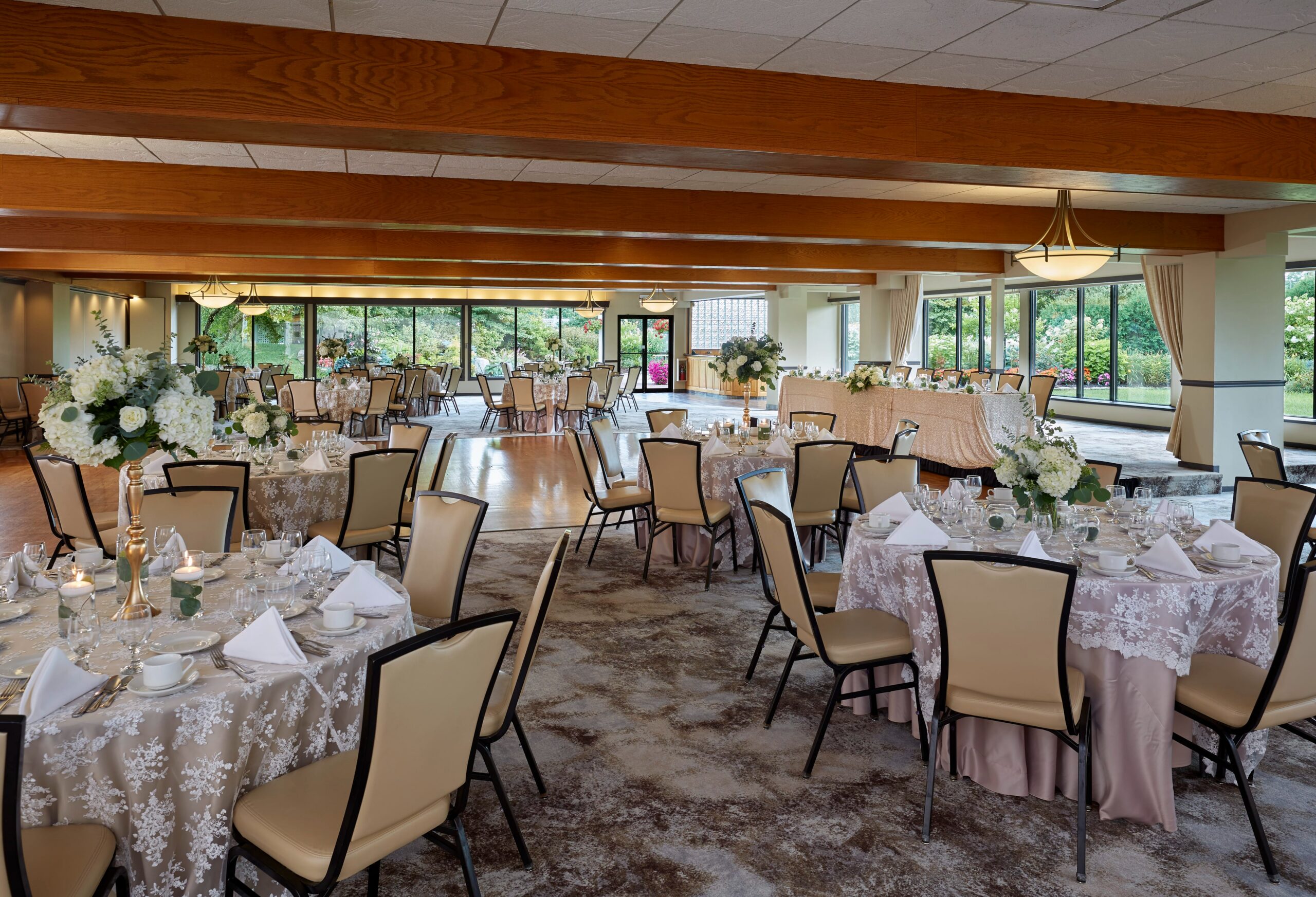 Many tables and chairs are set up for an upcoming banquet at the West Garden Room.