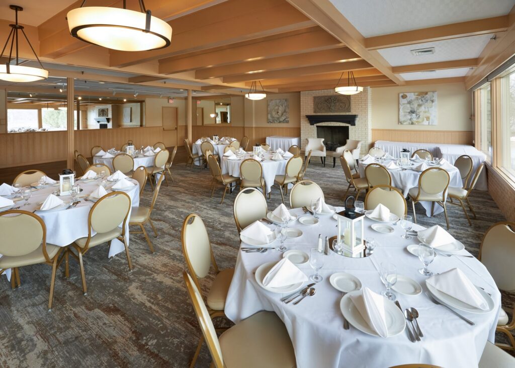 Many tables and chairs are set up for an upcoming banquet at the Club Room.